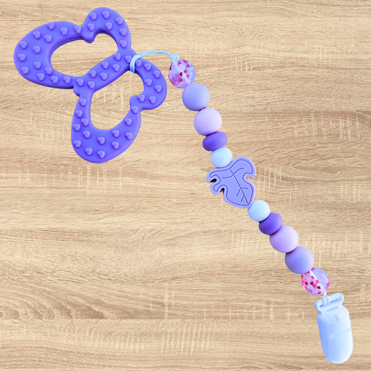 Attache-suce avec jouets de dentition